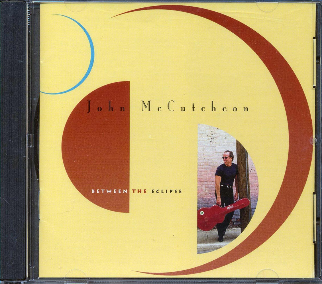 John McCutcheon - Between The Eclipse (marked/ltd stock)